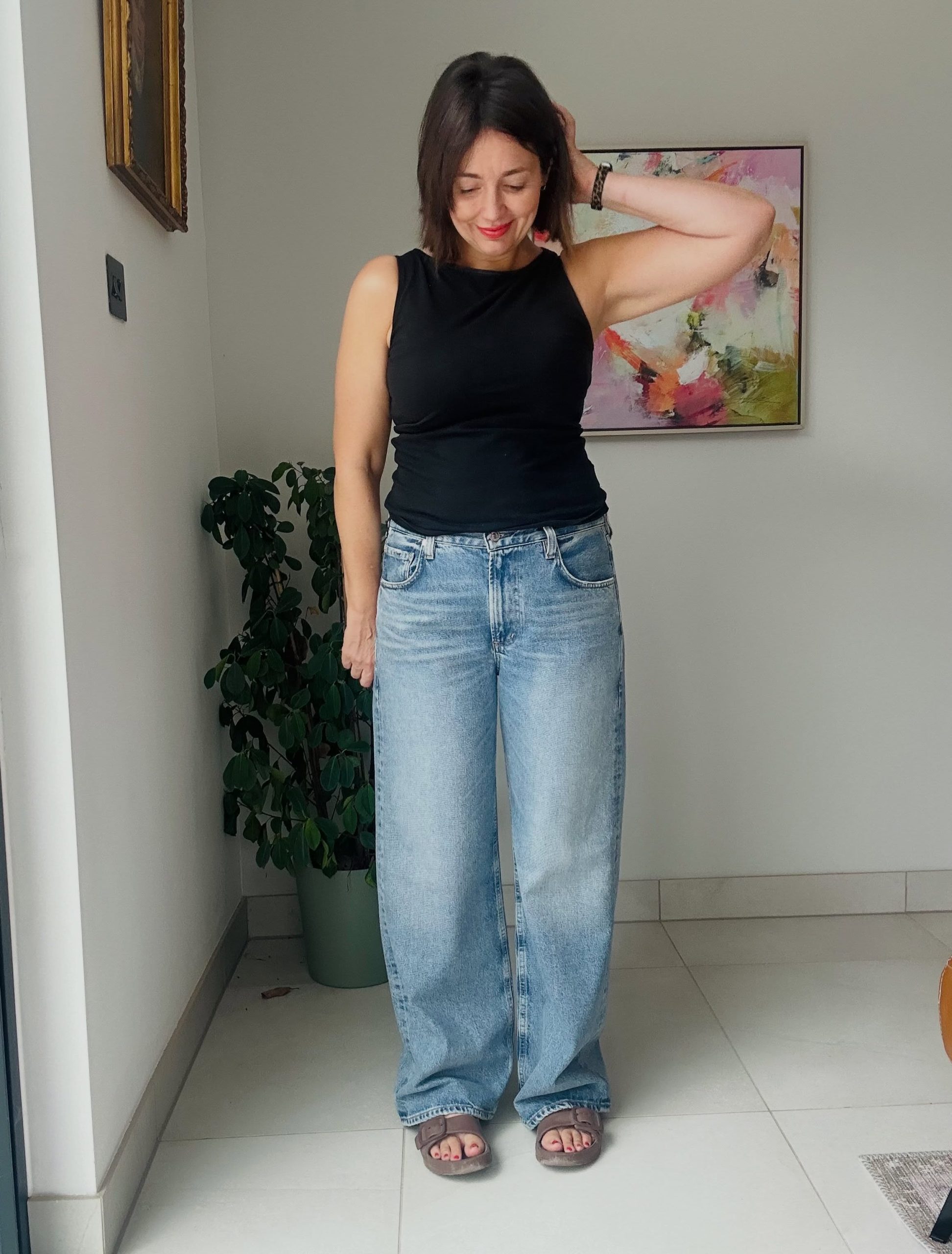 A Black Tank with Light Wide-Leg Jeans and Brown Sandals